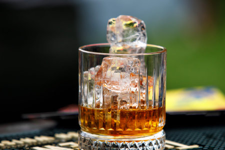 A glass of whiskey with ice