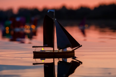 A lot of small paper boats at sunset. Toy fleet