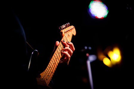 Hands on the guitar fretboard.