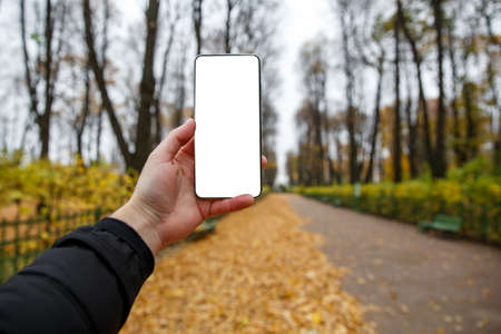 Using smartphone outdoor mockup - Empty white black screenの写真素材