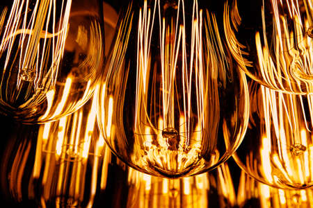 Warm light bulb, close up of filaments inside.の写真素材