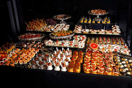 Catering services with various snacks on guest table in the restaurant at the event partyの写真素材