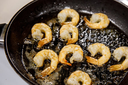 Fried shrimp on pan, preparing dish with seafoodの写真素材