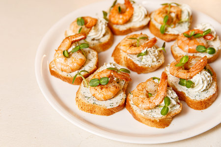 Small sandwiches with shrimps on a white plate