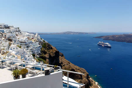 Cruise ship near Santorini island. White architecture and blue seaの写真素材