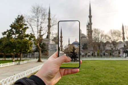 Taking photos of Istanbul, Turkey using a smartphone camera. Blue Mosque on the screenの写真素材