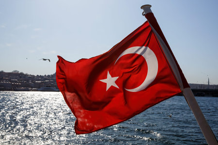 Waving Turkey flag and Istanbul view from water - travel backgroundの写真素材