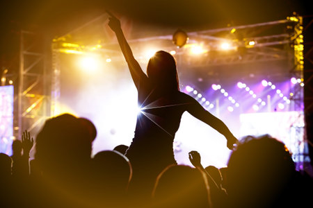 Girl on shoulders in the crowd at a music festival.