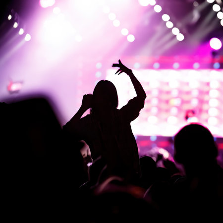 Girl on shoulders in the crowd at a music festival.