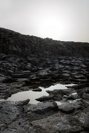 Volcanic landscape. Cooled lava is black rocky texture
