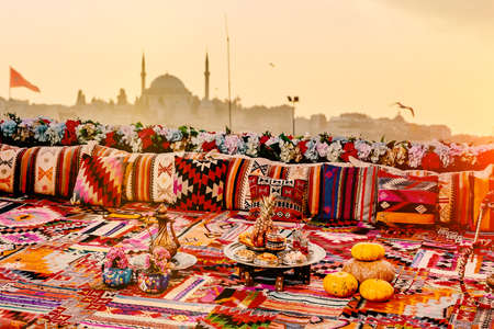 Panoramic view of Istanbul from a high terrace decorated with traditional authentic colorful ornamental pillows and carpets.の写真素材
