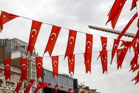 The row of many Turkish flags against cloudy sky