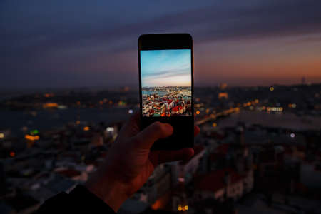 Istanbul at sunset, Turkey. Taking a photo cityscape by cell phoneの写真素材