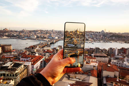Istanbul at sunset, Turkey. Taking a photo cityscape by cell phoneの写真素材