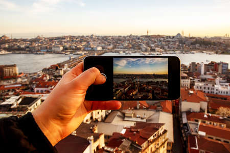 Istanbul at sunset, Turkey. Taking a photo cityscape by cell phoneの写真素材