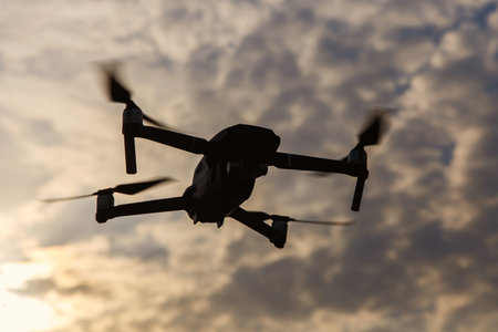 Silhouette of a drone against dramatic clouds in the sky