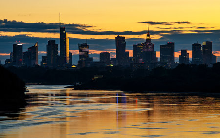 Warsaw skyline during orange sunset, The line of skyscrapers black silhouettesの写真素材