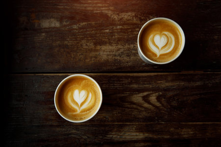 Love date concept. Two coffee cups with a heart latte artの写真素材