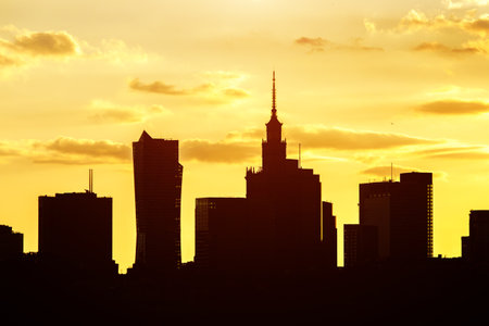 Big city skyline of Warsaw, Poland. Silhouettes Of modern skyscrapers and the famous Palace of Science and Cultureの写真素材