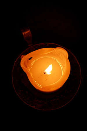 Flame of burning candle with dripping wax.の写真素材