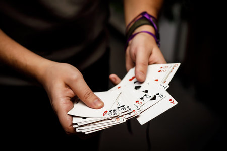 Playing cards in the hands of the player, close-up.