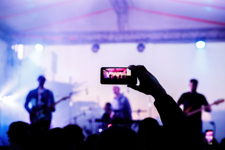 People on the dance floor are shooting a concert on a mobile phoneの写真素材