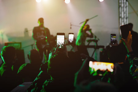 People on the dance floor are shooting a concert on a mobile phoneの写真素材