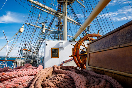 Sailship deck with helm, rigging and cables