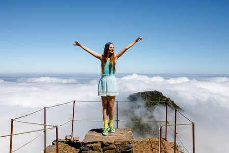Happy traveler, woman with raised hands in Madeira island, Portugalの写真素材