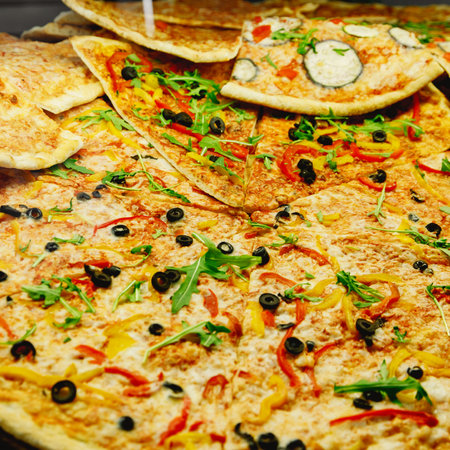 Sliced pizza on a thin crustの写真素材