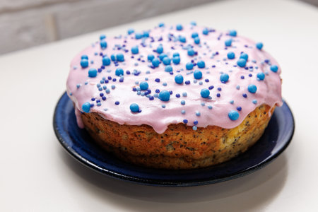 Glazed poppy easter cake with blue ...の写真素材