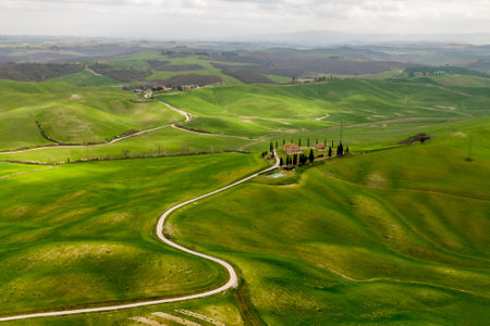 Italian countryside view with a road to a hilltop home in Tuscanyの写真素材