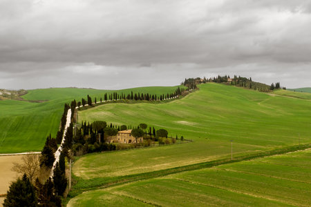 Italian countryside scenery featuring a hilltop residence in Tuscanyの写真素材