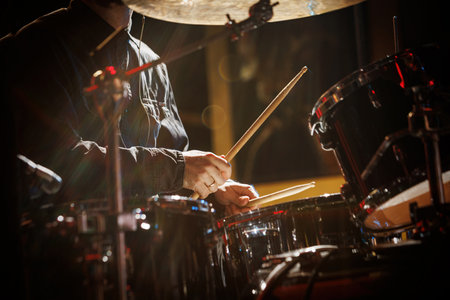 The drummer plays with drumsticks on the rock drum set.の写真素材