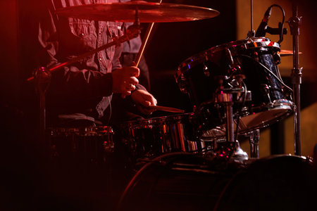 The drummer plays with drumsticks on the rock drum set.の写真素材