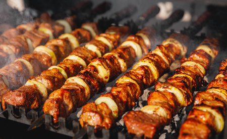 Skewered meat cooking on a coalの写真素材