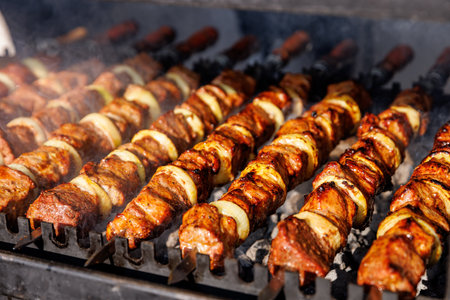 Skewered meat cooking on a coalの写真素材