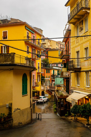 Yellow and red bright houses on narrow traditional streets of an Italian townの写真素材