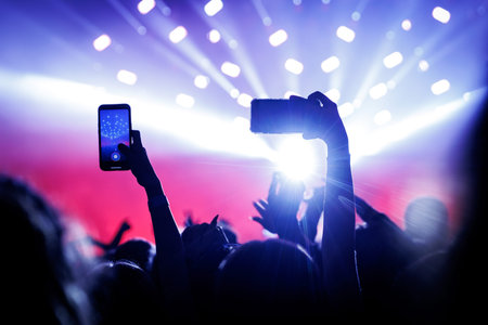 Smartphone crowd at a music event.
