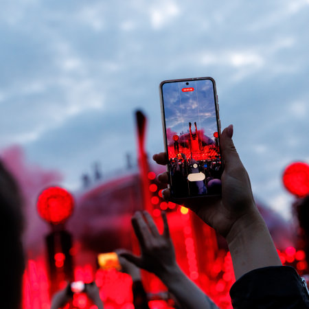 Smartphones in the Hands of the Crowd at an Outdoor Music Eventの写真素材