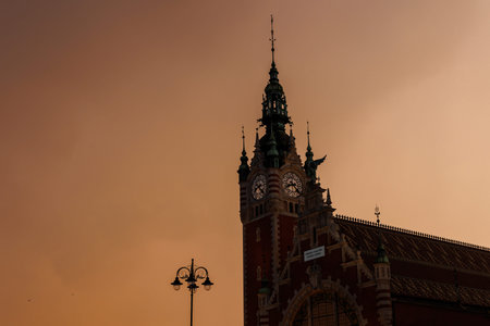 Tower of an old building in the Dutch neo-renaissance style. Sunset dramatic clouds