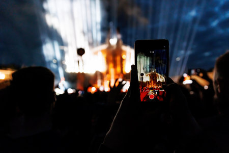 People Taking Photos At A Music Concert With Smartphones