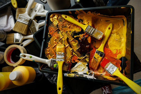 Brushes in paint while painting