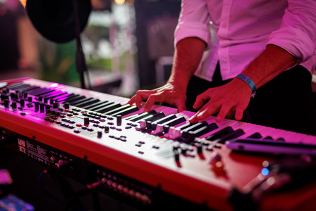 Musician playing electronic musical keyboard synthesizerの写真素材
