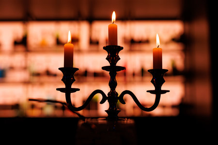 Elegant candlelight from a classic candelabra illuminates a room.の写真素材