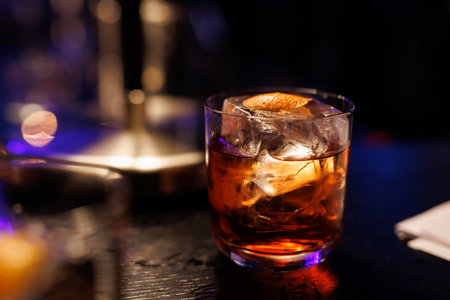 A glass of whiskey on the bar counter.
