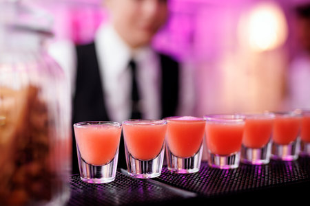 The row of alcohol shots on the bar counter, ready to drink