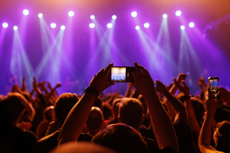 A mesmerizing moment unfolds at a live concert, recorded via mobile phone cameraの写真素材