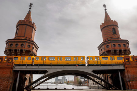 Yellow Berlin metro train on the historic Oberbaum Bridge.