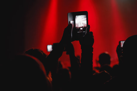 A mesmerizing moment unfolds at a live concert, recorded via mobile phone camera